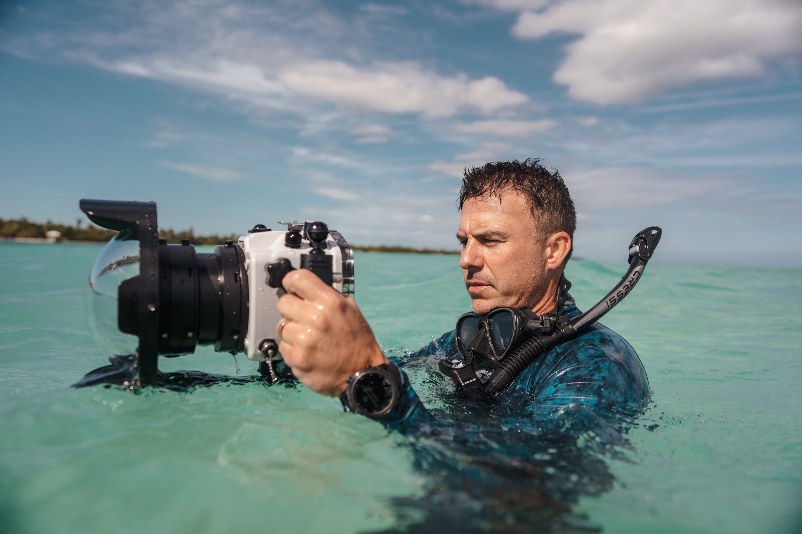 Steel House founder Tom Nagel filming in the water with an underwater housing on a Cressi shoot in Belize.